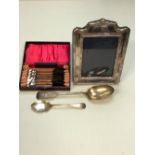 A HALLMARKED SILVER FRONTED PHOTO FRAME, TOGETHER WITH, A VICTORIAN SILVER SERVING SPOON, A SET OF