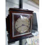 AN ART DECO MAHOGANY AND EBONY CASED MANTEL CLOCK RETAILED BY J HALL & Co. MANCHESTER, THE TIMEPIECE