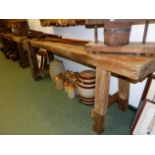 AN ANTIQUE RUSTIC LONG WORKBENCH WITH FITTED VICE 230 X 78 CM HIGH