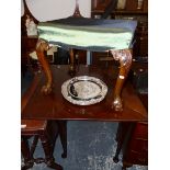 A 19th C. MAHOGANY FOLD OVER CORNER TABLE AND A GEORGIAN STYLE CABRIOLE LEGGED STOOL.