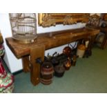 AN ANTIQUE RUSTIC LONG WORKBENCH WITH FITTED VICE 234 CM WIDE X 75 CM HIGH