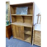 AN ARTS AND CRAFT OAK CABINET WITH SLIDING DOORS.
