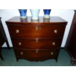 A SMALL INLAID MAHIGANY THREE DRAWER BOW FRONT CHEST