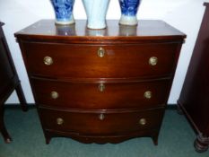 A SMALL INLAID MAHIGANY THREE DRAWER BOW FRONT CHEST