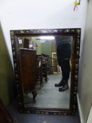 AN ANTIQUE EBONISED AND MOTHER OF PEARL INLAID WALL MIRROR.