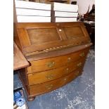 A LARGE ANTIQUE CONTINENTAL OAK BUREAU.