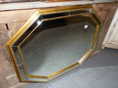 AN OCTAGONAL MARGINAL FRAMED MIRROR.