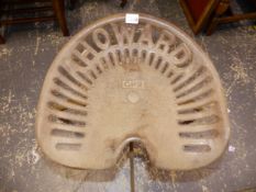 A HOWARD CAST IRON TRACTOR SEAT ON STOOL SUPPORT.