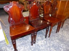 A PAIR OF VICTORIAN MAHOGANY HALL CHAIRS WITH CARTOUCHE BACKS, TOGETHER WITH A FURTHER PAIR OF