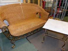 A WROUGHT IRON AND RATTAN CONSERVATORY TWO SEAT SETTEE AND MATCHING COFFEE TABLE.