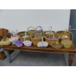 A COLLECTION OF VARIOUS VINTAGE AND LATER HAND FLOWER BASKETS, TRUGS, ETC.