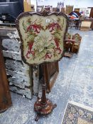 A VICTORIAN ROSE WOOD POLE SCREEN WITH NEEDLE POINT PANEL.