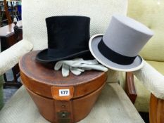 A LEATHER CASED BLACK TOP HAT BY WOODROW & SONS, TOGETHER WITH A GREY TOP HAT.