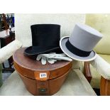 A LEATHER CASED BLACK TOP HAT BY WOODROW & SONS, TOGETHER WITH A GREY TOP HAT.