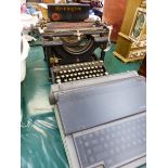 A VINTAGE REMINGTON TYPEWRITER, AND AN OLIVETTI TYPEWRITER.