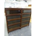 A PAIR OF GLOBE WERNICKE LEAD GLAZED FOUR TIER BOOKCASES. W 86 X D 30 X H 147cms.