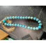 A STRING OF LARGE TURNED TURQUOISE BEADS, APPORX 2.5cm DIAMETER, VARIOUS FACET CUT DRESS RINGS,