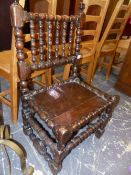 AN EARLY OAK LOW SIDE CHAIR WITH BOBBIN SUPPORTS. SEAT HIGHT 36cms