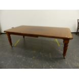 A VICTORIAN MAHOGANY WIND OUT EXTENDING DINING TABLE ON TURNED LEGS COMPLETE WITH TWO LEAVES AND