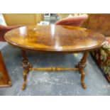 A VICTORIAN BURR WALNUT OVAL CENTRE TABLE ON CARVED SUPPORTS AND CABRIOLE LEGS. W 106 X D 61 X H