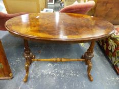 A VICTORIAN BURR WALNUT OVAL CENTRE TABLE ON CARVED SUPPORTS AND CABRIOLE LEGS. W 106 X D 61 X H