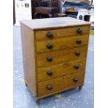 A 19th C. SCUMBLED PINE SMALL CHEST OF FIVE LONG GRADUATED DRAWERS WITH BUN HANDLES, STANDING ON
