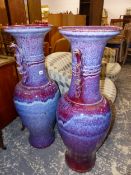 A PAIR OF LARGE ORIENTAL LARVA GLAZED FLOOR URNS, TOGETHER WITH AN ART DECO STYLE LARGE URN. THE