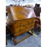 A SMALL OAK BUREAU, AND AN OAK STAND. W 74 X D 41 X H 99.