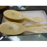 A GROUP OF IVORY BACKED DRESSING TABLE BRUSHES, A MIRROR AND GLOVE STRETCHER.