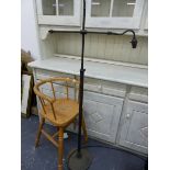 A CHILDS HIGH CHAIR AND A STANDARD LAMP.