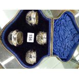 A CASED SET OF FOUR HALLMARKED SILVER SALTS.