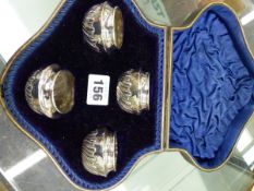 A CASED SET OF FOUR HALLMARKED SILVER SALTS.