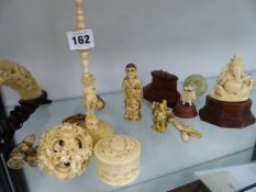 A LARGE ANTIQUE IVORY PUZZLE BALL, A CARVED BOARS TUSK BRIDGE, VARIOUS ORNAMENTS, ETC.