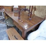 A HARDWOOD WRITING TABLE ON SQUARE TAPERED LEGS.