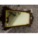 AN ANTIQUE FRET FRAMED WALL MIRROR WITH BEVELLED GLASS PLATE. H 82 X W 46cms.