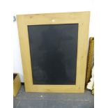 A LARGE OAK FRAMED CHALK BOARD. 122 X 153cms.