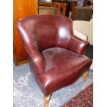 A LEATHER UPHOLSTERED ARM CHAIR, AND AN UNUSUAL LOW SWIVEL TUB CHAIR.