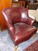 A LEATHER UPHOLSTERED ARM CHAIR, AND AN UNUSUAL LOW SWIVEL TUB CHAIR.