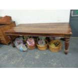 A LARGE HARDWOOD DINING TABLE ON TURNED SUPPORTS, WITH IRON CORNER MOUNTS TO STRETCHERS. L 220 X W