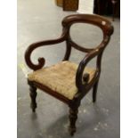 A VICTORIAN MAHOGANY BALLOON BACKED ELBOW CHAIR, THE ARMS WITH SCROLLED FRONTS ABOVE THE DROP IN