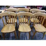 A SET OF SIX PINE SPINDLE BACK KITCHEN CHAIRS.