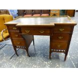 A GOOD QUALITY LATE VICTORIAN BREAKFRONT MAHOGANY WRITING DESK, 3/4 BRASS GALLERY BANKS OF DRAWERS.