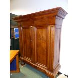 A LARGE CONTINENTAL WALNUT TWO DOOR ARMOIRE.