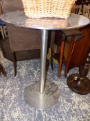 A RETRO STAINLESS STEEL TABLE. DIAMETER 60 X HEIGHT 89cms.
