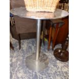 A RETRO STAINLESS STEEL TABLE. DIAMETER 60 X HEIGHT 89cms.