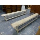 A NEAR PAIR OF ANTIQUE LIMED OAK FORMS / BENCHES ON SPLAY TURNED LEGS WITH PERIPHERY STRETCHER. L