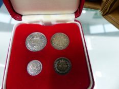 THREE SILVER PROOF COINS, A BOXED FOUR PIECE MAUNDY COIN SET.
