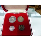 THREE SILVER PROOF COINS, A BOXED FOUR PIECE MAUNDY COIN SET.