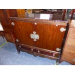 AN MID 20th C. MAHOGANY SIDE CABINET ON TWO DRAWER BASE STAND. W 120 X D 51 X H 130cms.