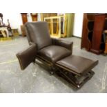 A LATE VICTORIAN DARK LEATHER ADJUSTABLE ARM CHAIR WITH SLIDE UNDER FOOT REST, THE ARMS HINGED AT